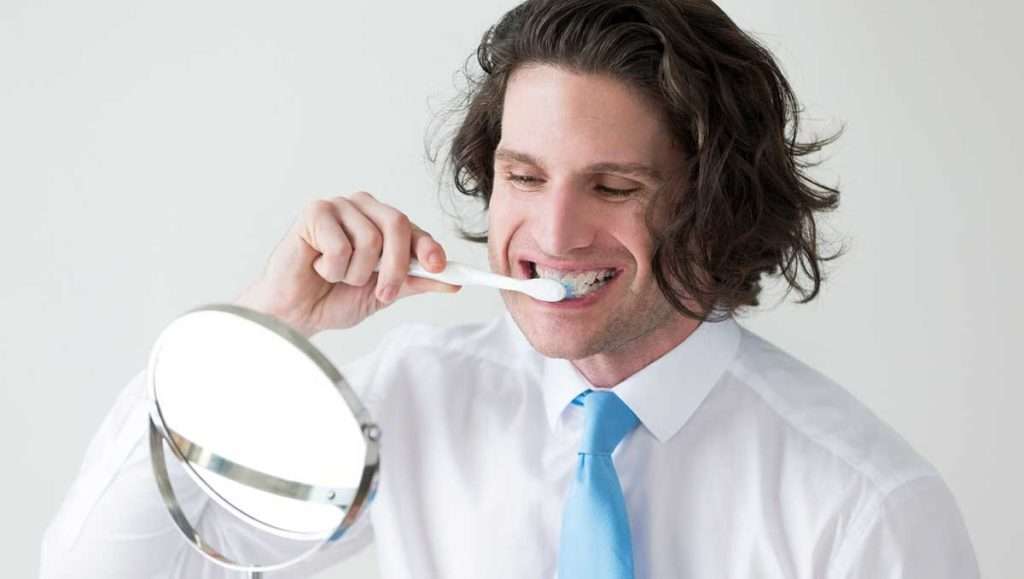 man brushing teeth