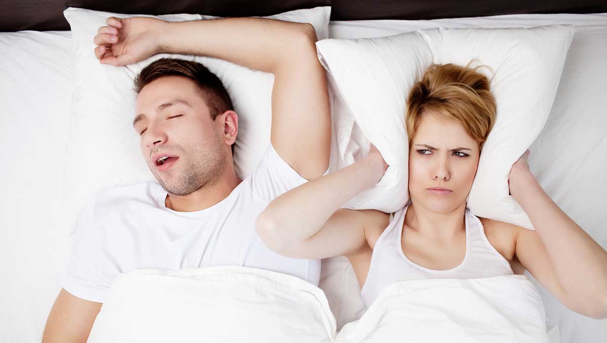 Man snoring with his partner