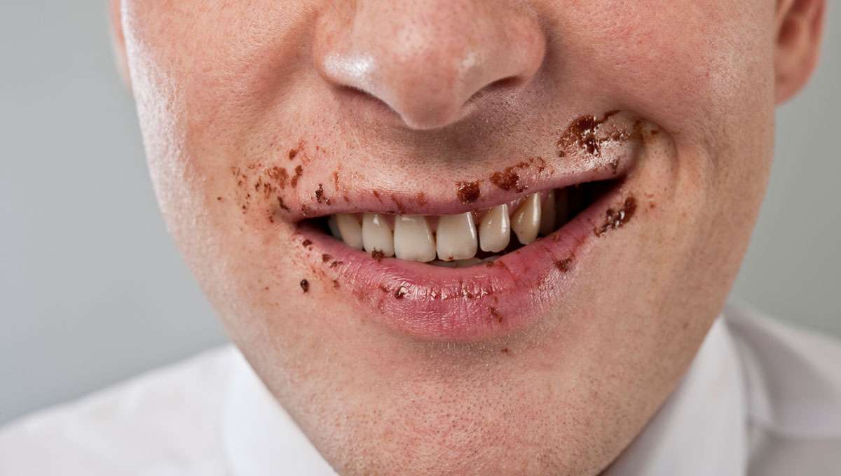 Man who has eaten a chocolate snack