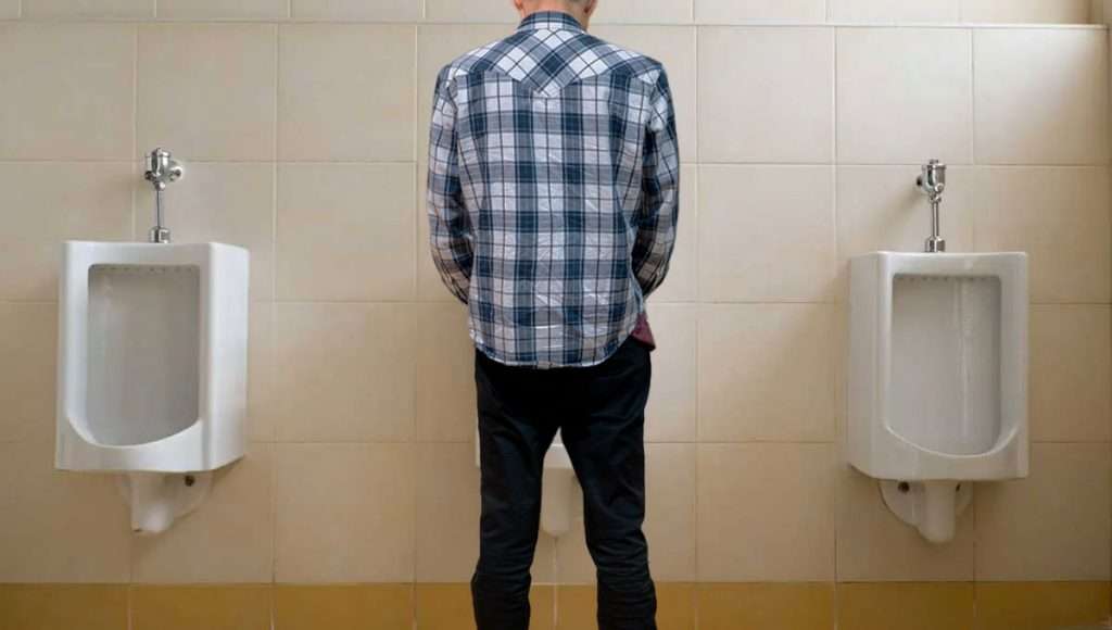 man at urinal
