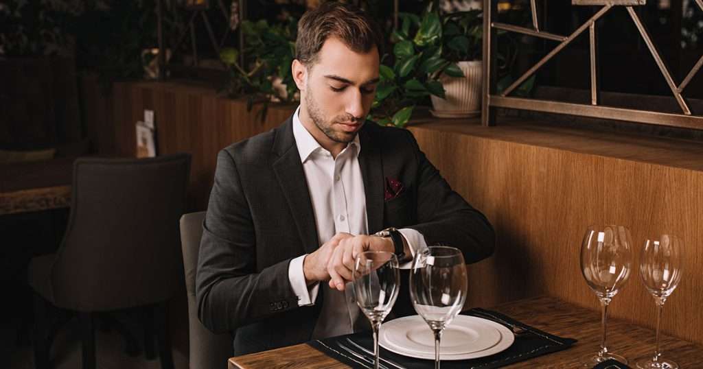 man in restaurant waiting with empty plate