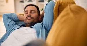 man relaxing on the sofa