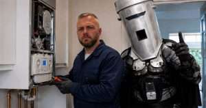 Rob Kenyon repairing Count Binface's boiler
