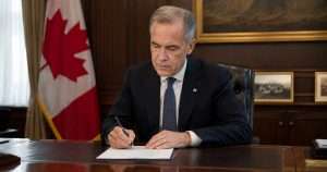 Mark Carney signing document