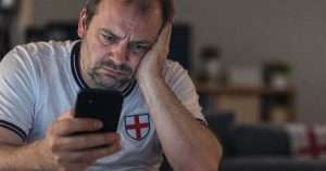 unhappy patriot looking at his phone